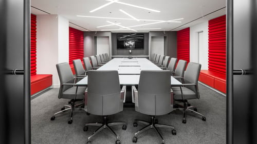 corporate boardroom with long meeting table and stylish office chairs